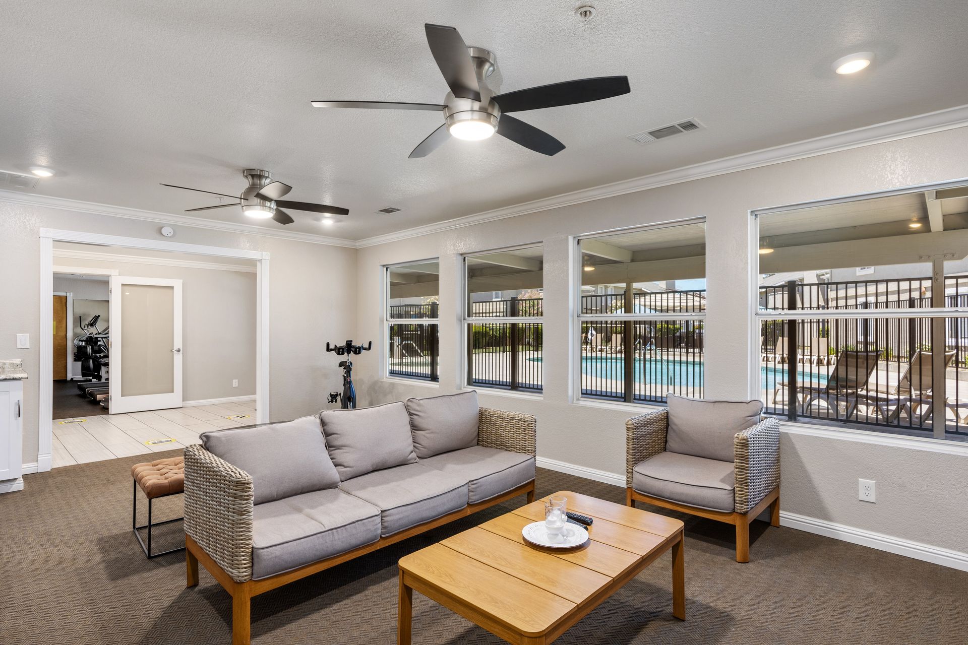 Clubhouse sitting room with windows looking out over the pool deck